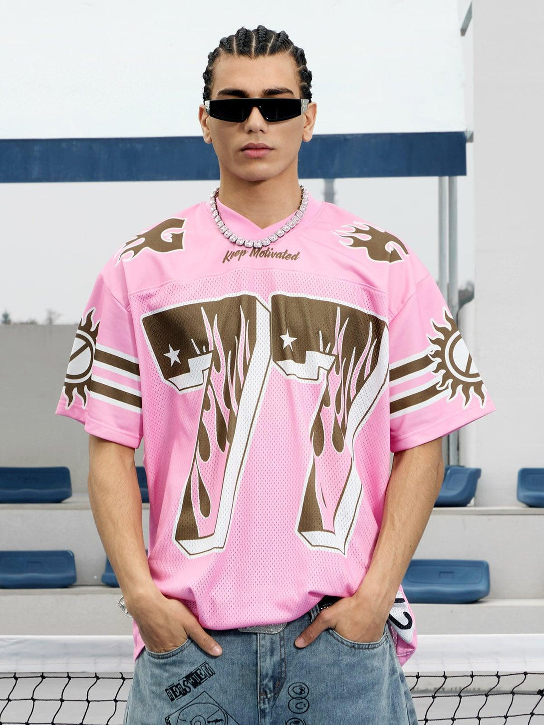 Model in TALISHKO pink flame print jersey T-shirt and sunglasses, exuding summer vibes.