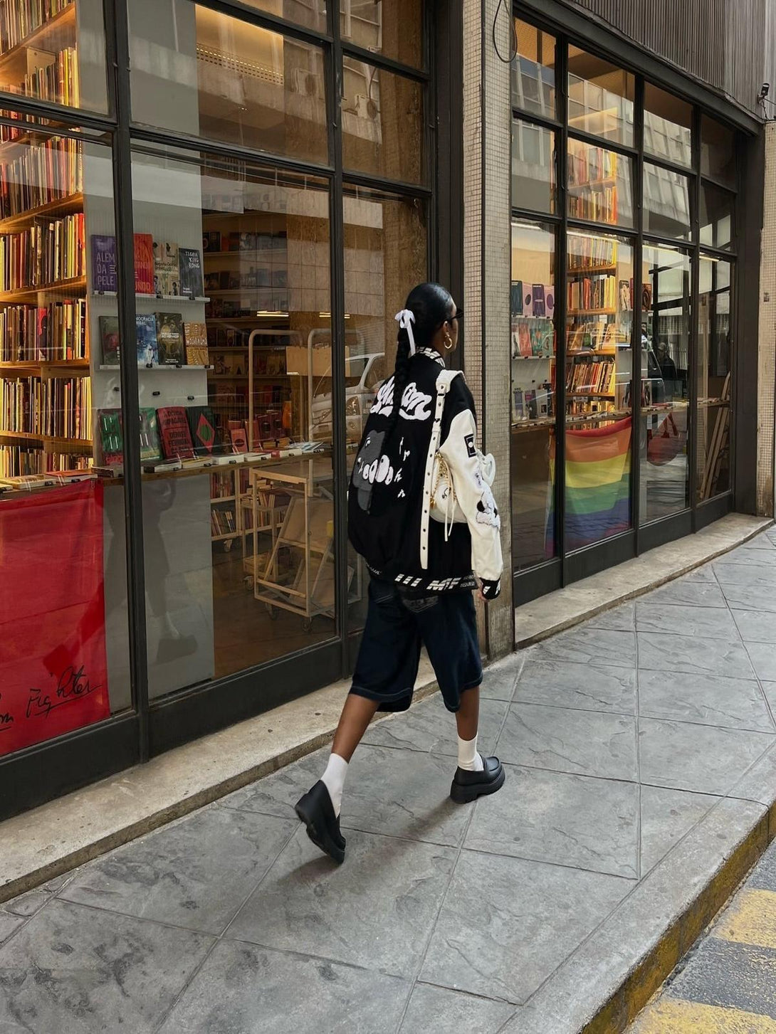 Urban street style featuring a TALISHKO baseball jersey with bold embroidery and patches.