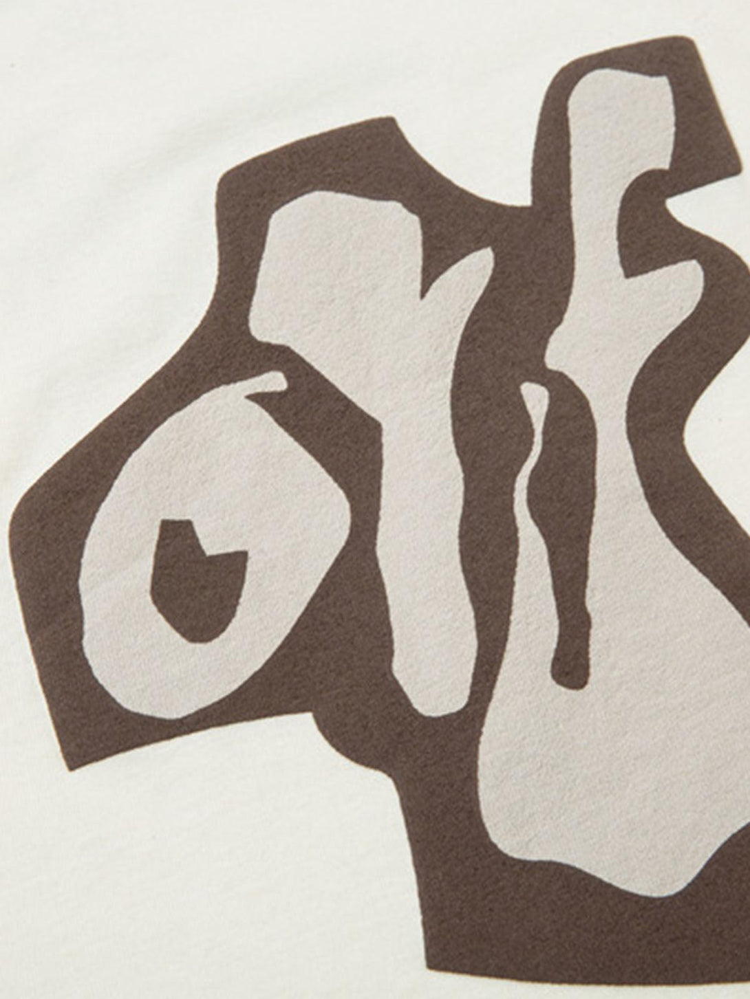 A detailed view of abstract graphics on a TALISHKO T-shirt, emphasizing playful design elements.