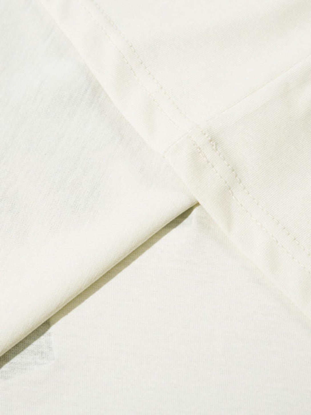 Close-up of TALISHKO T-shirt fabric, highlighting its soft texture and precise stitching.
