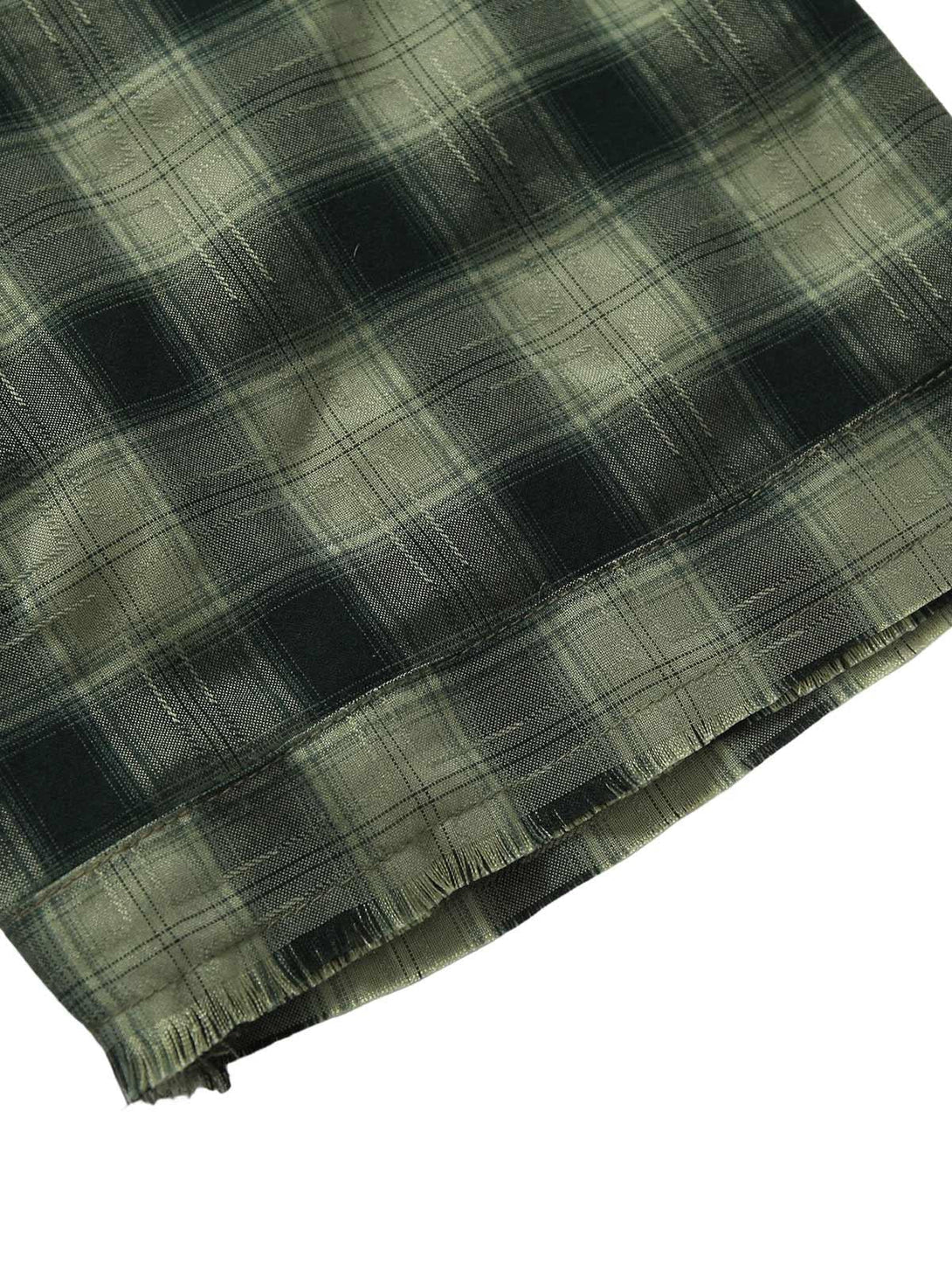 A close-up of TALISHKO's plaid shirt hem, showcasing the textured fabric and fringe detailing.