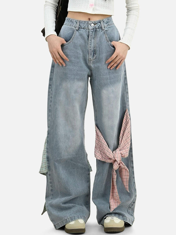 Model wearing TALISHKO loose jeans with plaid bow accents, showcasing casual chic style.