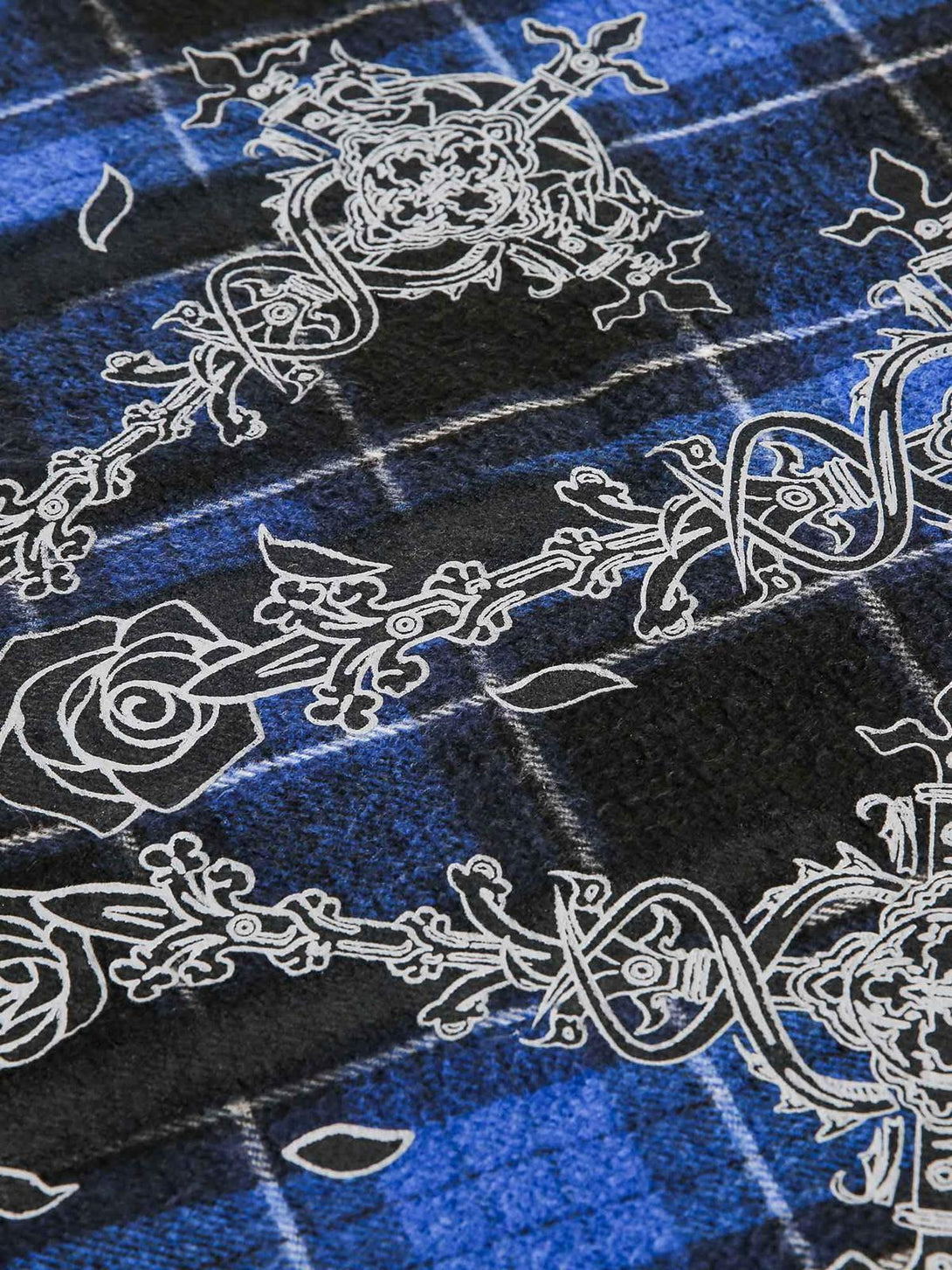 Intricate design on TALISHKO's blue plaid fabric, showcasing the unique embroidered detail.