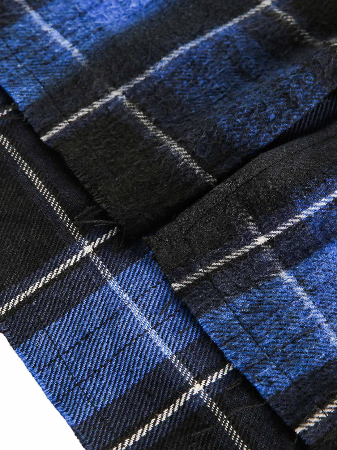 Zoomed-in texture of TALISHKO's blue plaid fabric, highlighting its soft, brushed detail.