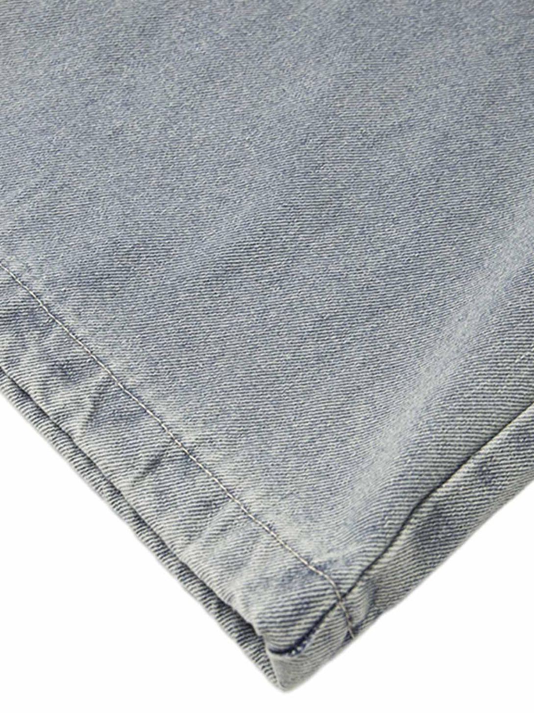 Detailed fabric and stitching on TALISHKO baggy jeans, showcasing unique texture.