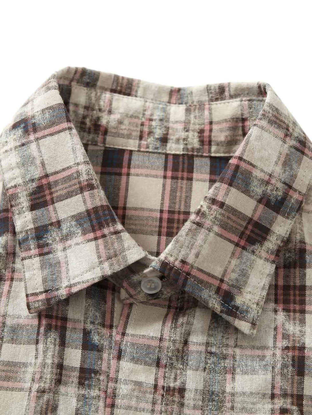 Intricate look at TALISHKO plaid shirt collar, showcasing graffiti-inspired design details.