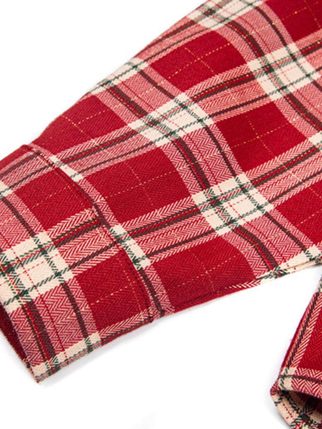 A detailed view of TALISHKO's red plaid shirt fabric, highlighting its classic pattern and texture.