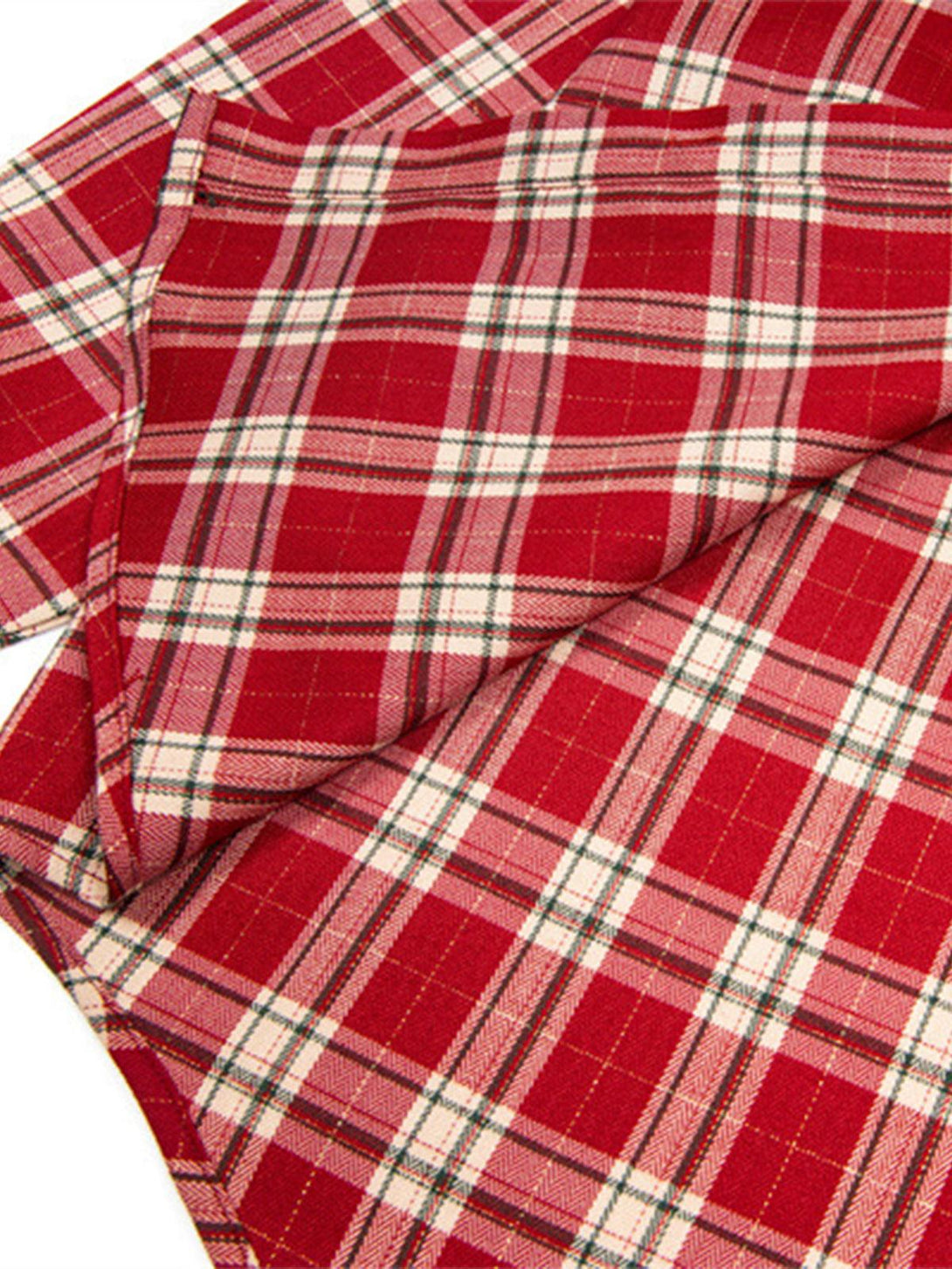 Intricate look at TALISHKO's red plaid fabric, showcasing its classic pattern and texture.