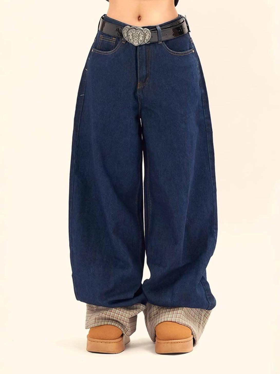 TALISHKO wide-leg jeans with a heart belt buckle, highlighting casual flair and plaid accents.