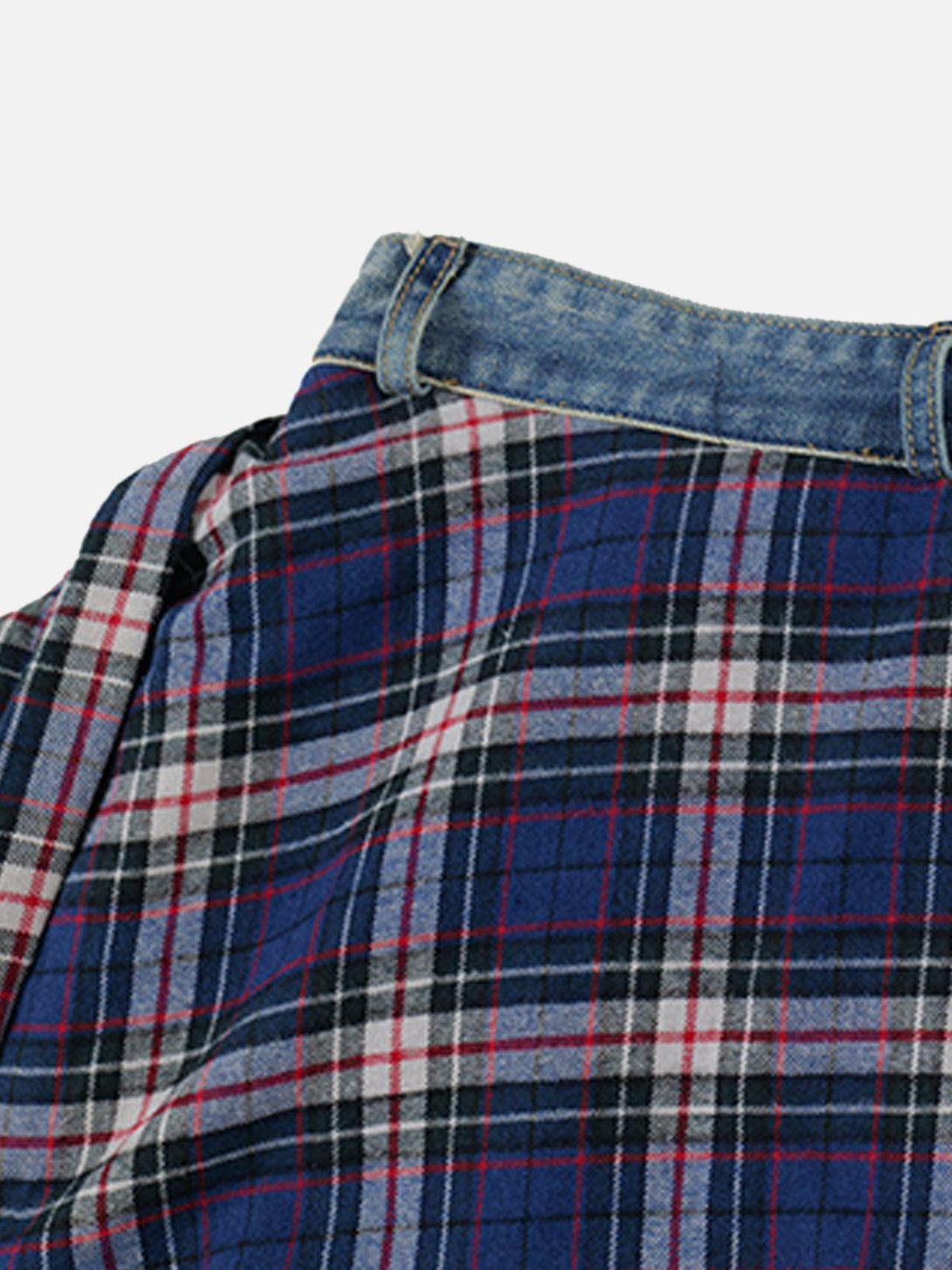 Detailed view of plaid patchwork jeans by TALISHKO, highlighting denim and flannel texture.