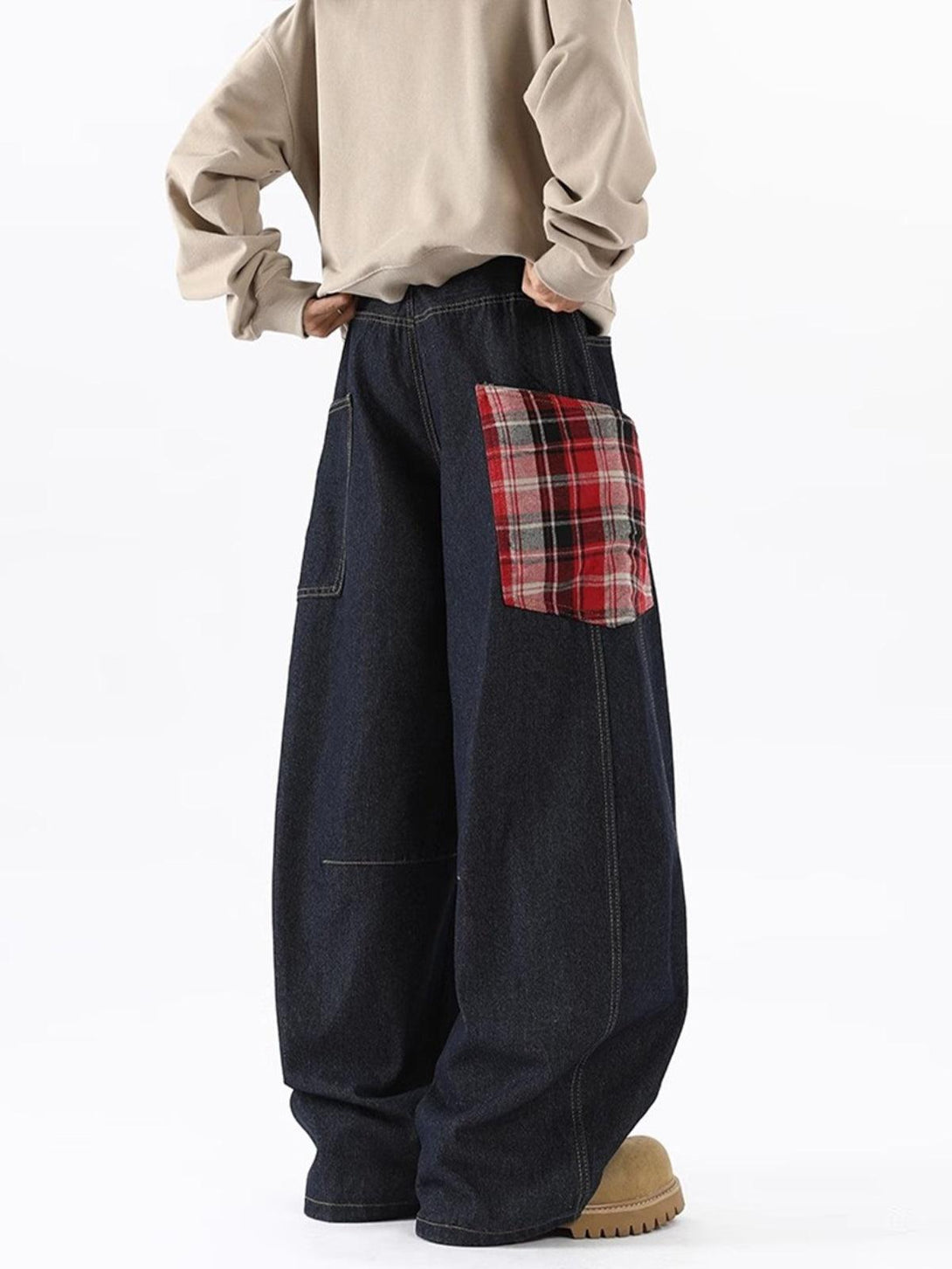 Wide-leg TALISHKO jeans featuring a plaid pocket, styled with a beige top for a casual look.
