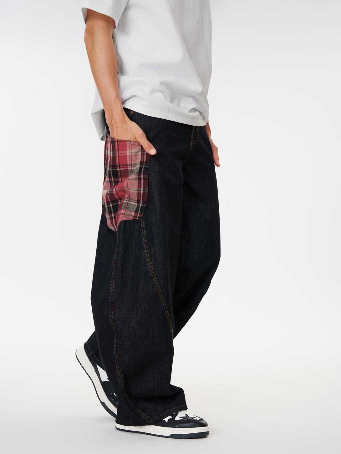 Model in TALISHKO barrel loose jeans with plaid pocket, styled with casual sneakers.