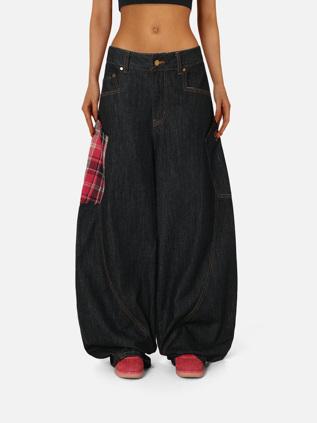 Model wearing TALISHKO barrel loose jeans with plaid pocket detail, paired with red sneakers.