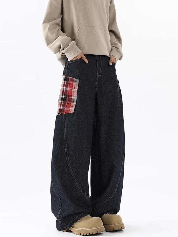 Model wearing TALISHKO loose jeans with plaid pocket detail, paired with a beige sweatshirt.