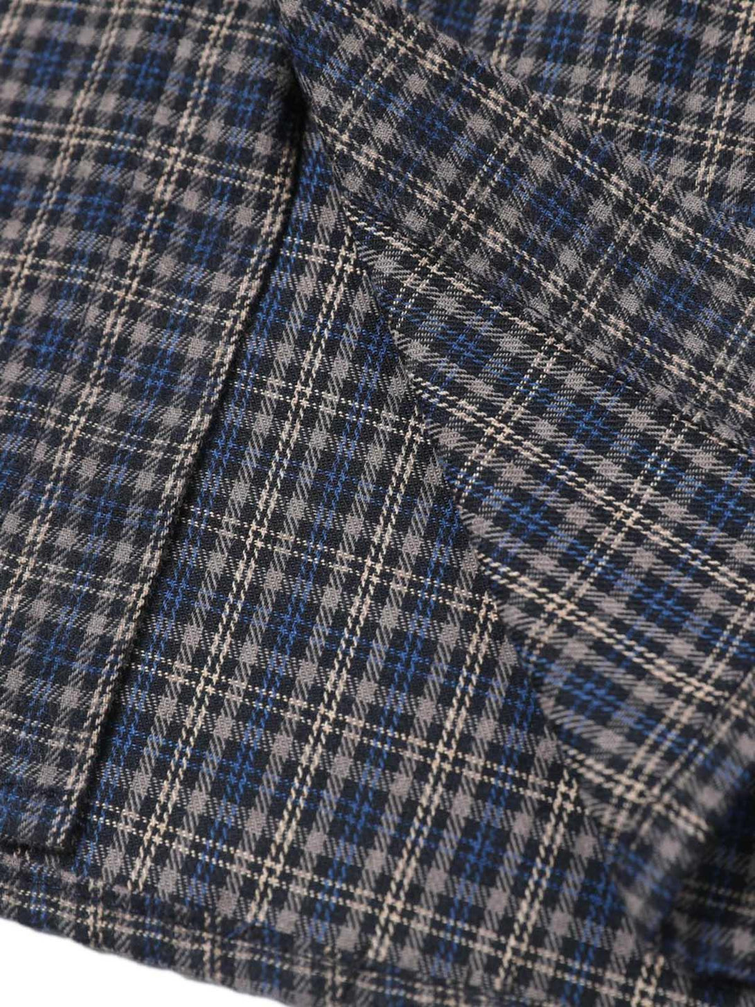 A close-up of the plaid pattern on TALISHKO's short sleeve polo shirt, highlighting its texture.