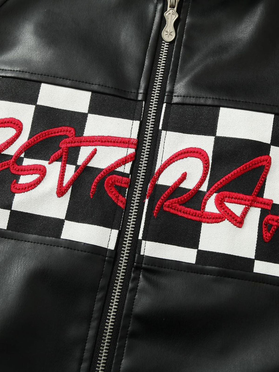 Intricate look at TALISHKO's leather jacket, featuring checkered pattern and red embroidery details.