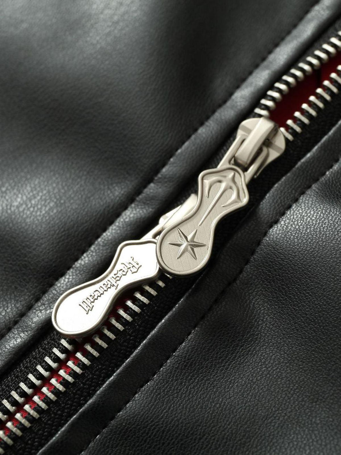 A detailed view of TALISHKO's leather jacket zipper, highlighting the sleek metal design.