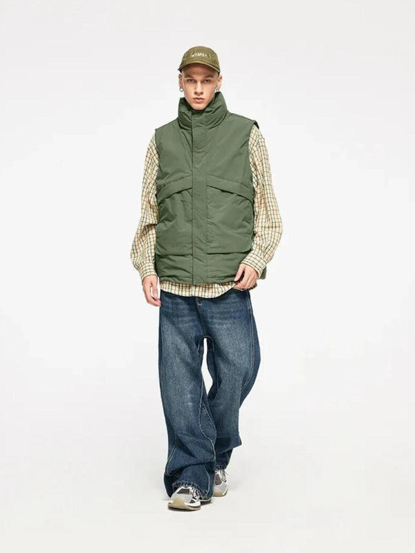 Model wearing a green windproof vest by TALISHKO, paired with relaxed jeans and sneakers.