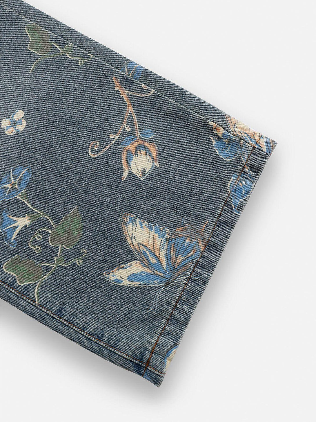 Intricate look at the botanical prints and butterfly design on TALISHKO jeans.