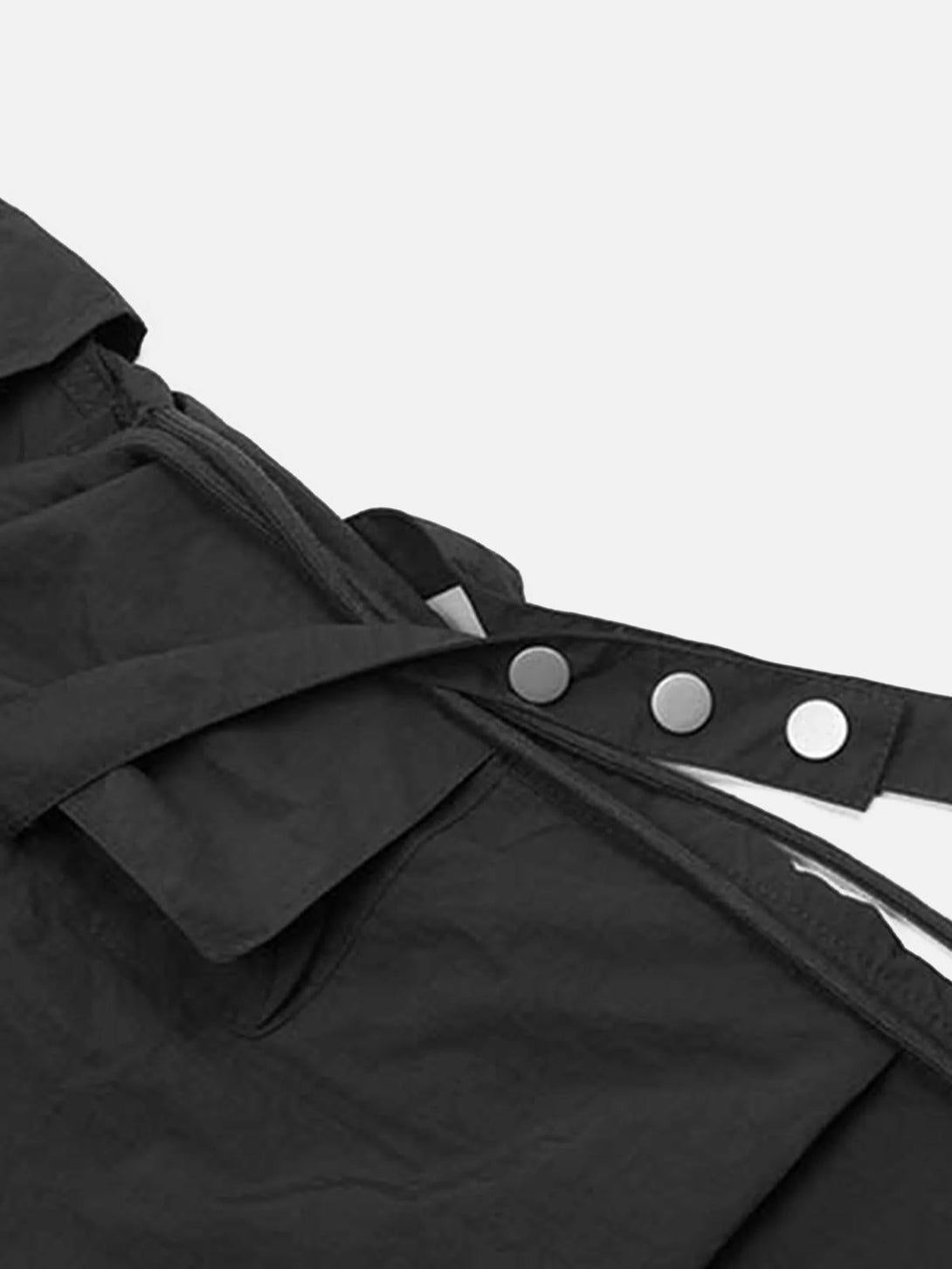 Detailed view of black TALISHKO cargo pants, showcasing bandage and drawstring button details.