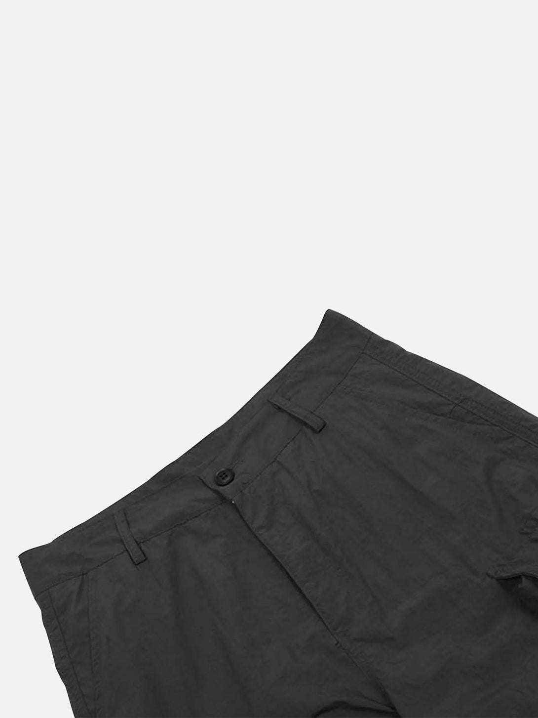 Close-up of black pleated cargo pants by TALISHKO, highlighting the waistband details.