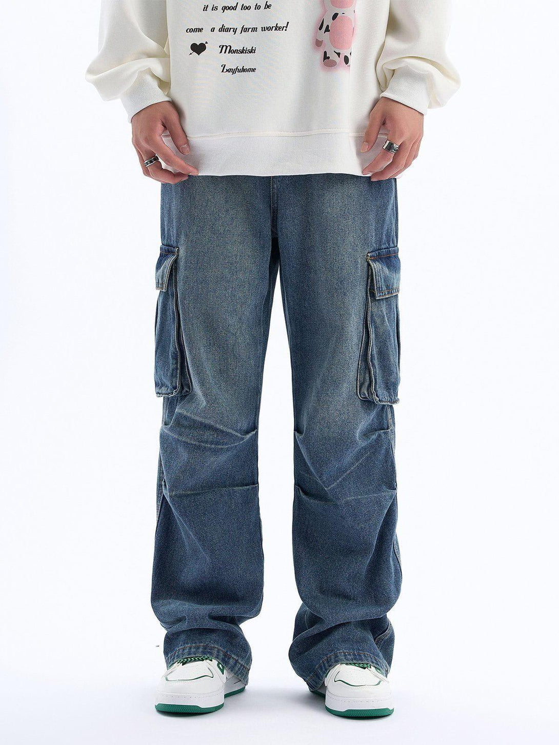 TALISHKO pleated multi-pocket jeans styled with a casual sweatshirt, front view.