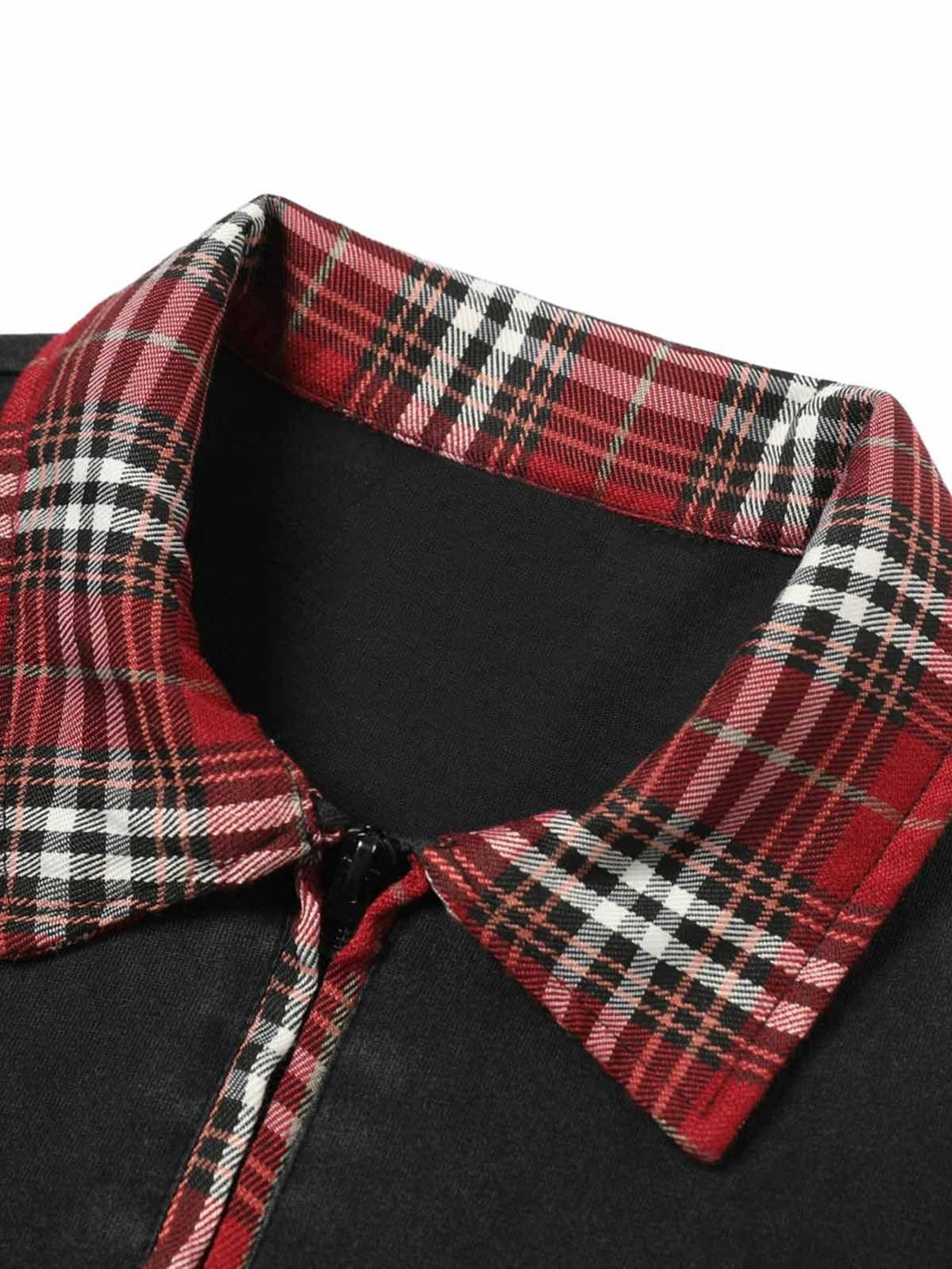 A close-up of TALISHKO's plaid lapel on a black polo T-shirt, highlighting its stylish detail.