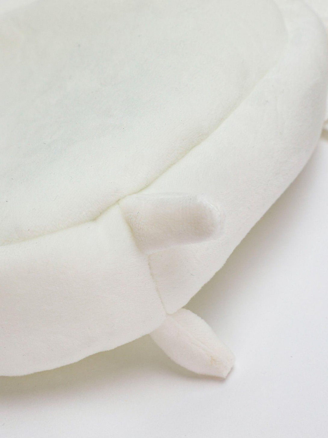 A detailed view of TALISHKO's plush cat crossbody bag, highlighting the soft fabric and stitching.