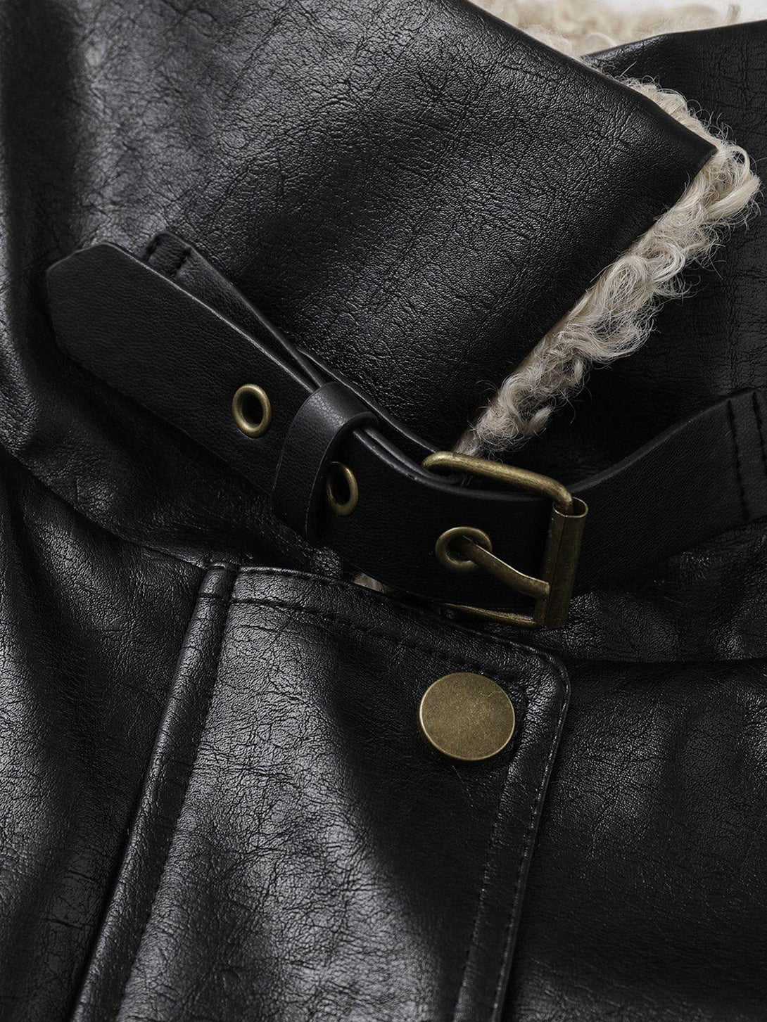 Focusing on the plush collar and buckle detail of the TALISHKO faux leather jacket.