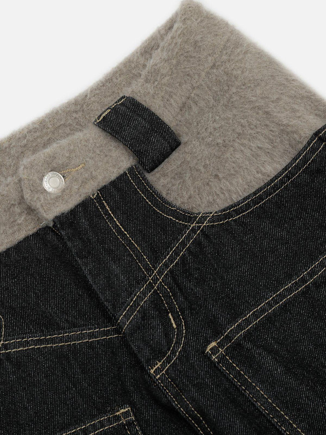 Intricate look at TALISHKO plush patchwork jeans' lining and stitching detail.