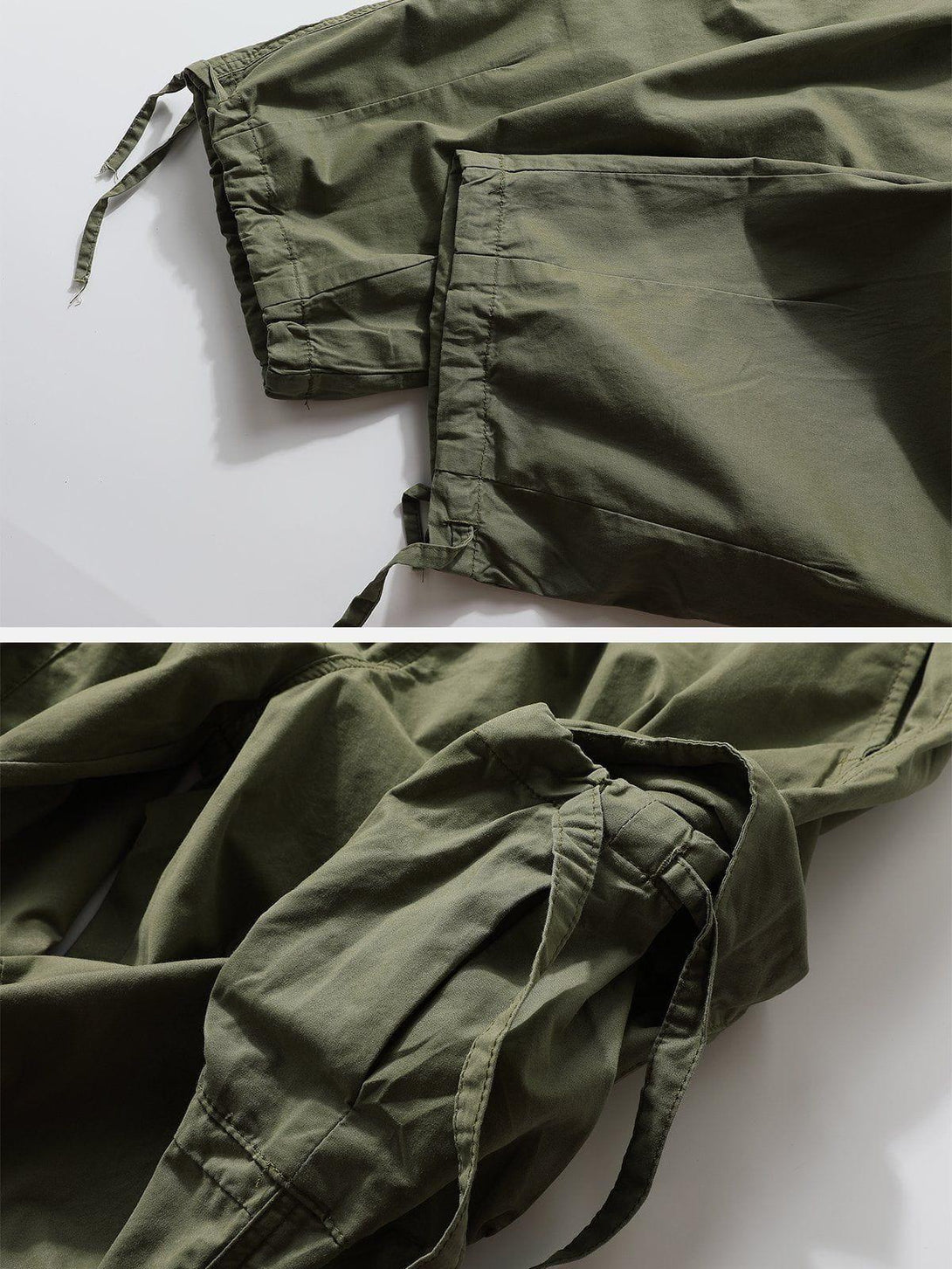 Close-up of green flap pocket pants by TALISHKO, highlighting drawstring and stitching details.