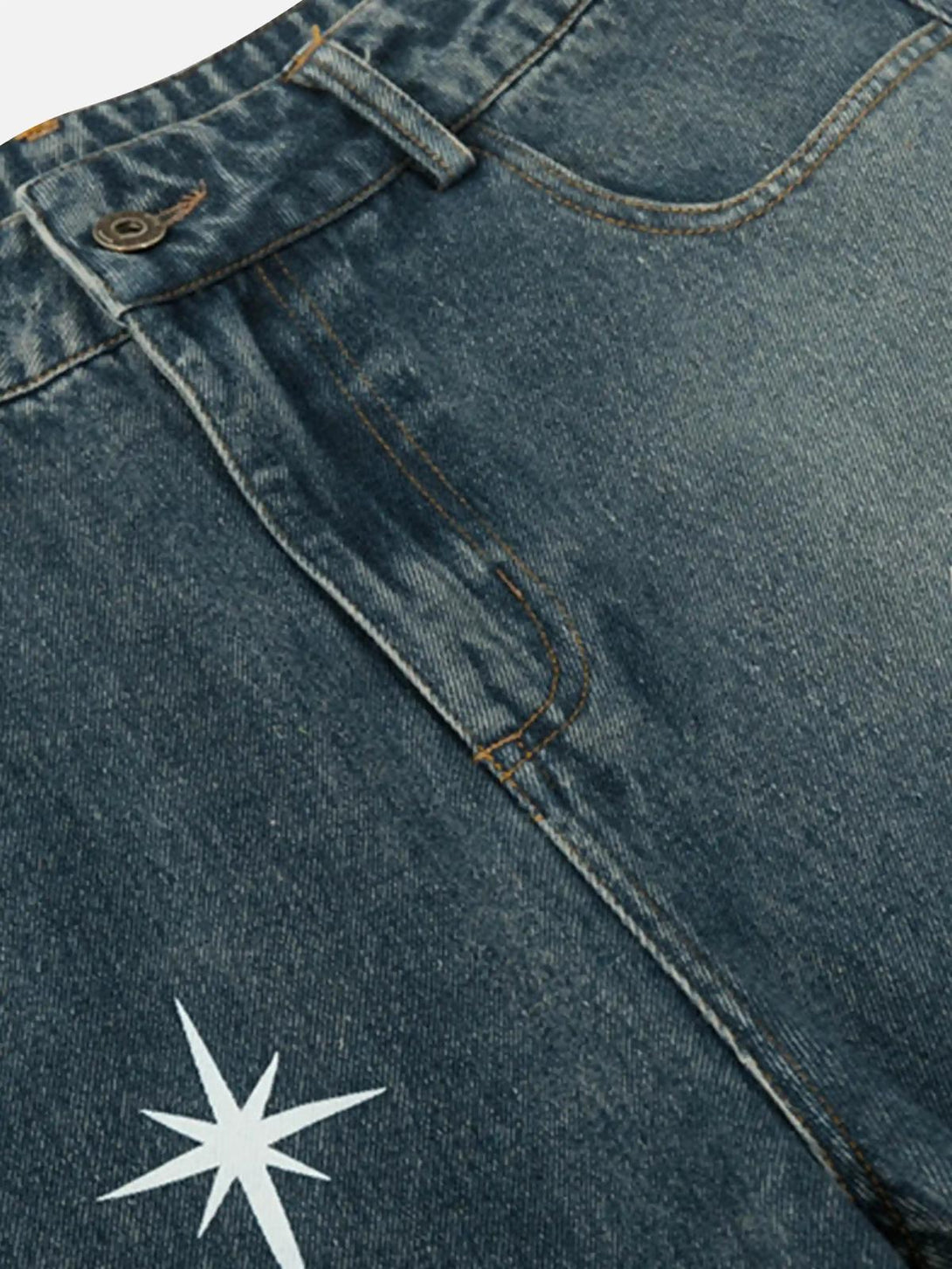A tight crop highlighting TALISHKO's washed denim with a star print, showcasing unique style.