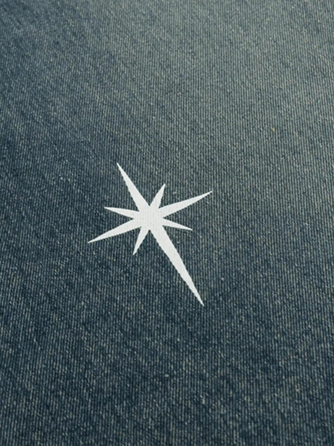 Focusing on the star motif, TALISHKO straight jeans' washed texture adds a chic touch.