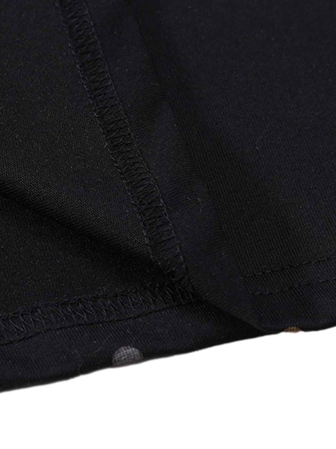"Detailed fabric and stitching on TALISHKO's black t-shirt, highlighting its quality craftsmanship."
