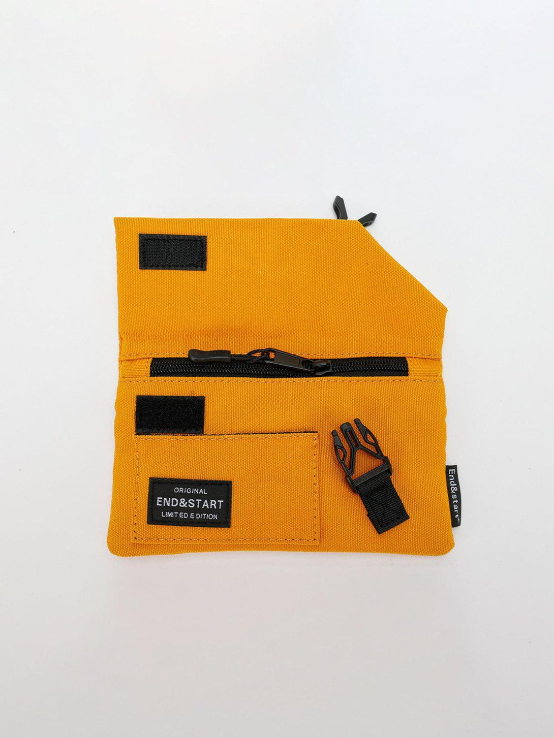 Portable mini crossbody bag by TALISHKO in yellow, featuring a front view with black accents.