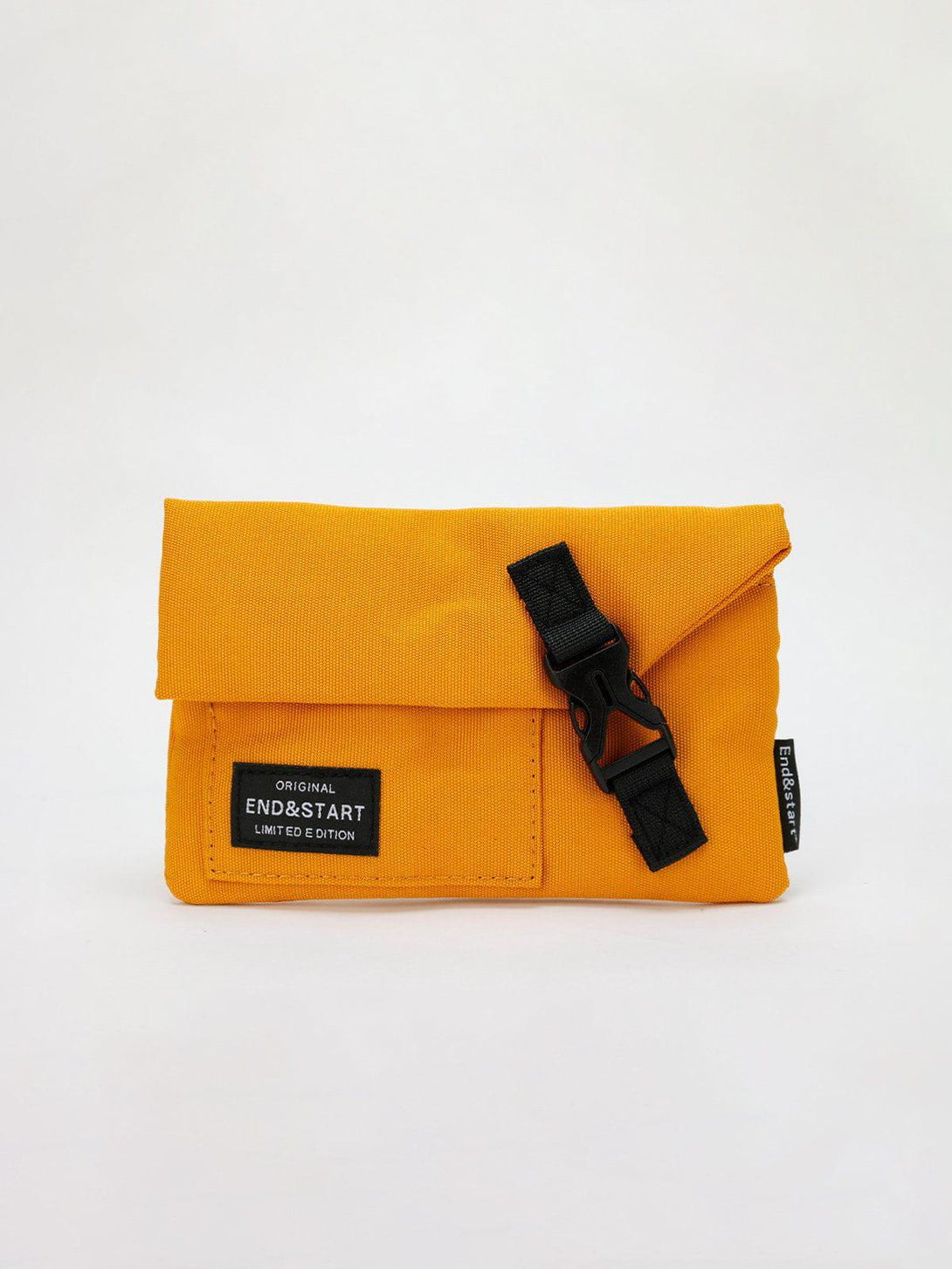 Compact yellow crossbody bag by TALISHKO with a secure black buckle, ideal for versatile styling.