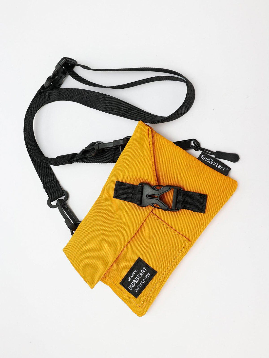 Compact yellow crossbody by TALISHKO, showcasing black accents and adjustable strap detail.