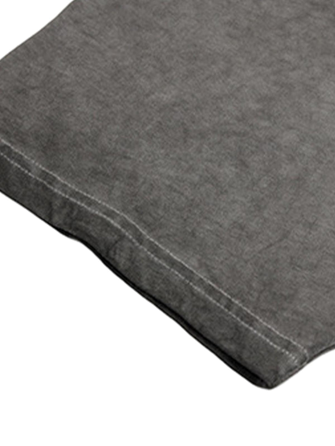 Focusing on the TALISHKO T-shirt's textured fabric and precise stitching details.