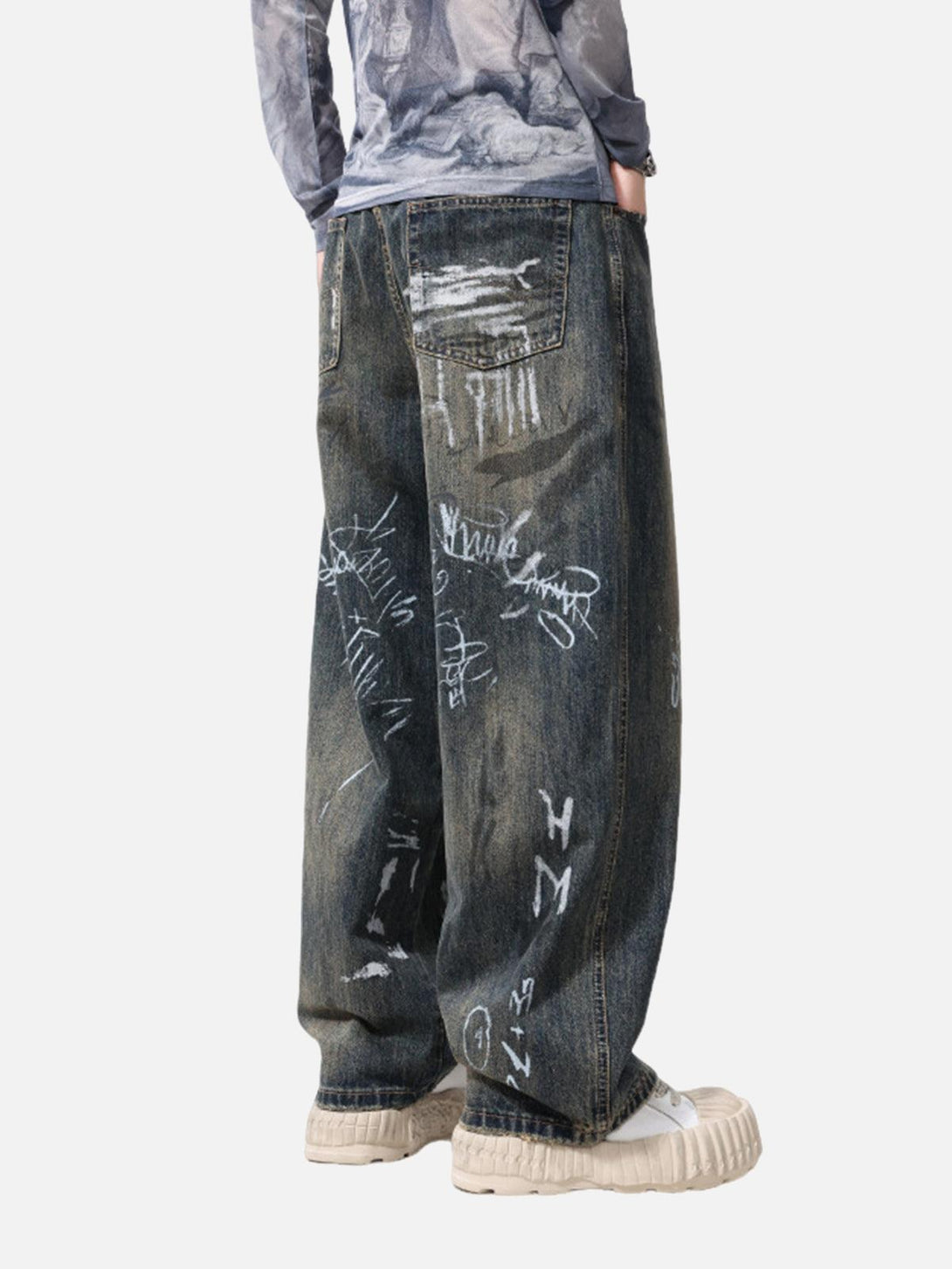 Model shows off TALISHKO baggy jeans with artistic graffiti and a relaxed, stylish fit.