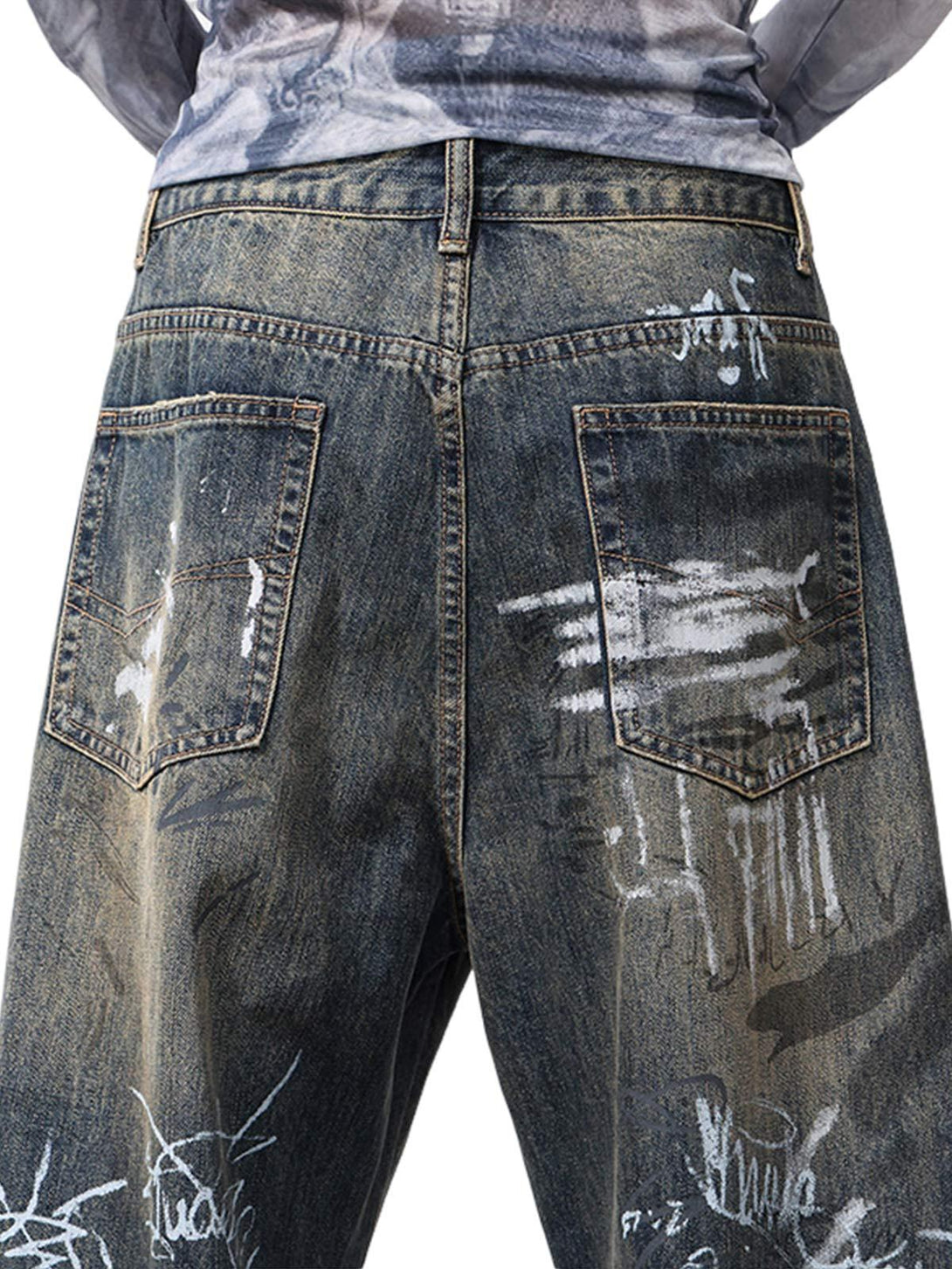 Back view of TALISHKO baggy jeans, featuring artistic hand-painted graffiti details.