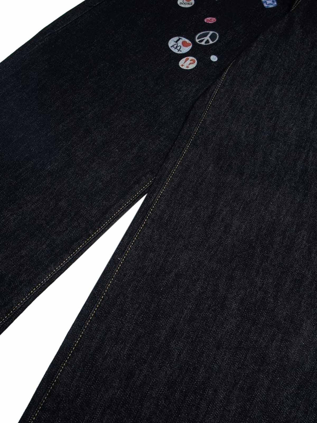 Focusing on playful print details on TALISHKO baggy jeans, highlighting unique style.