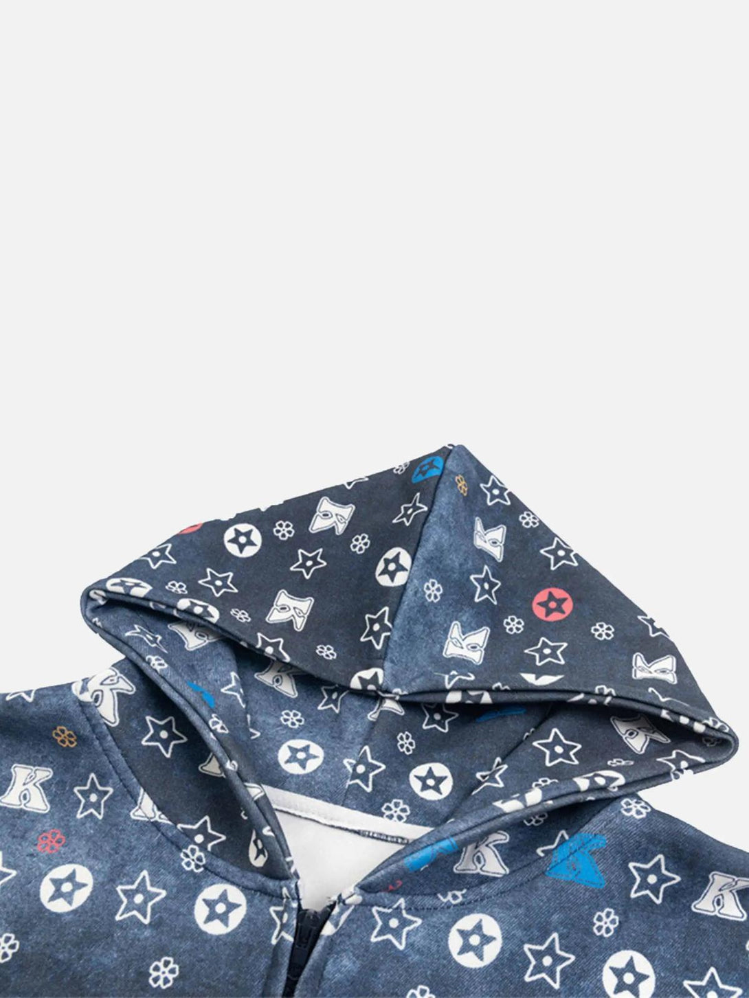 A close-up of TALISHKO hoodie hood with star and letter patterns on a gradient blue fabric.