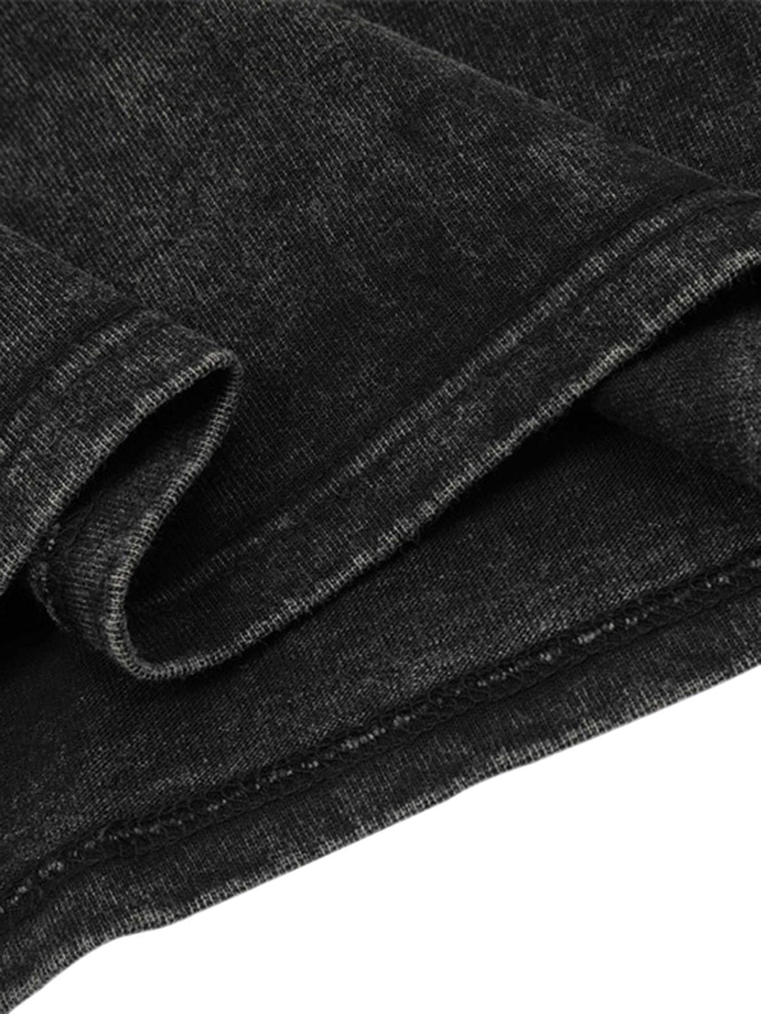 Intricate look at the textured fabric and stitching of a black TALISHKO T-shirt.