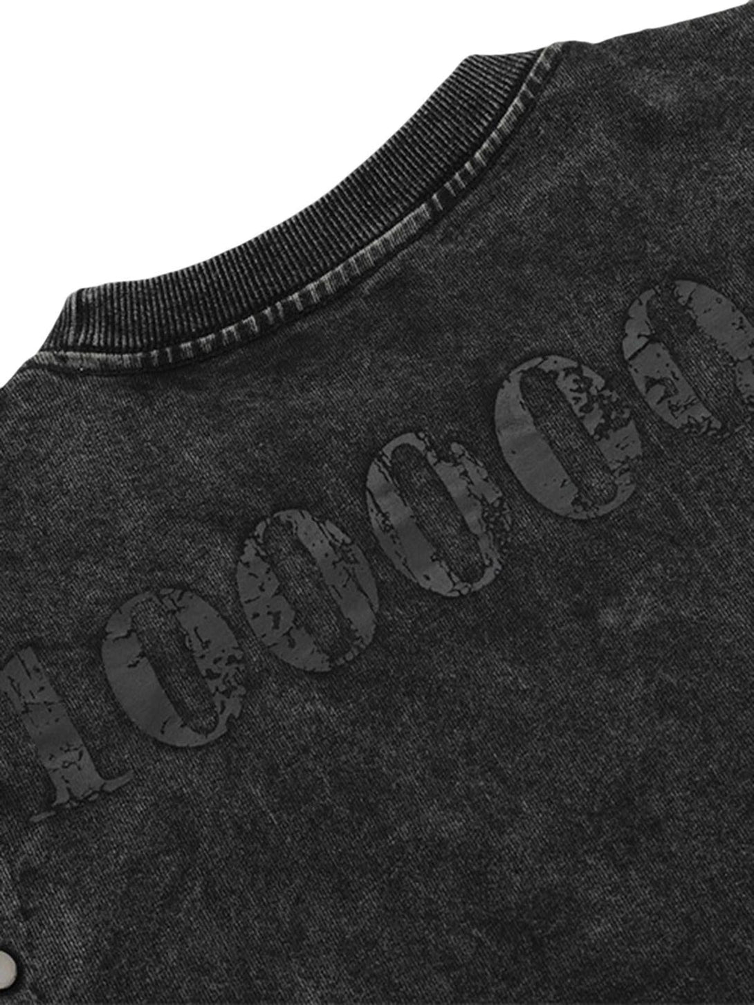 A tight crop highlighting the distressed "10000" detail on a black TALISHKO T-shirt.