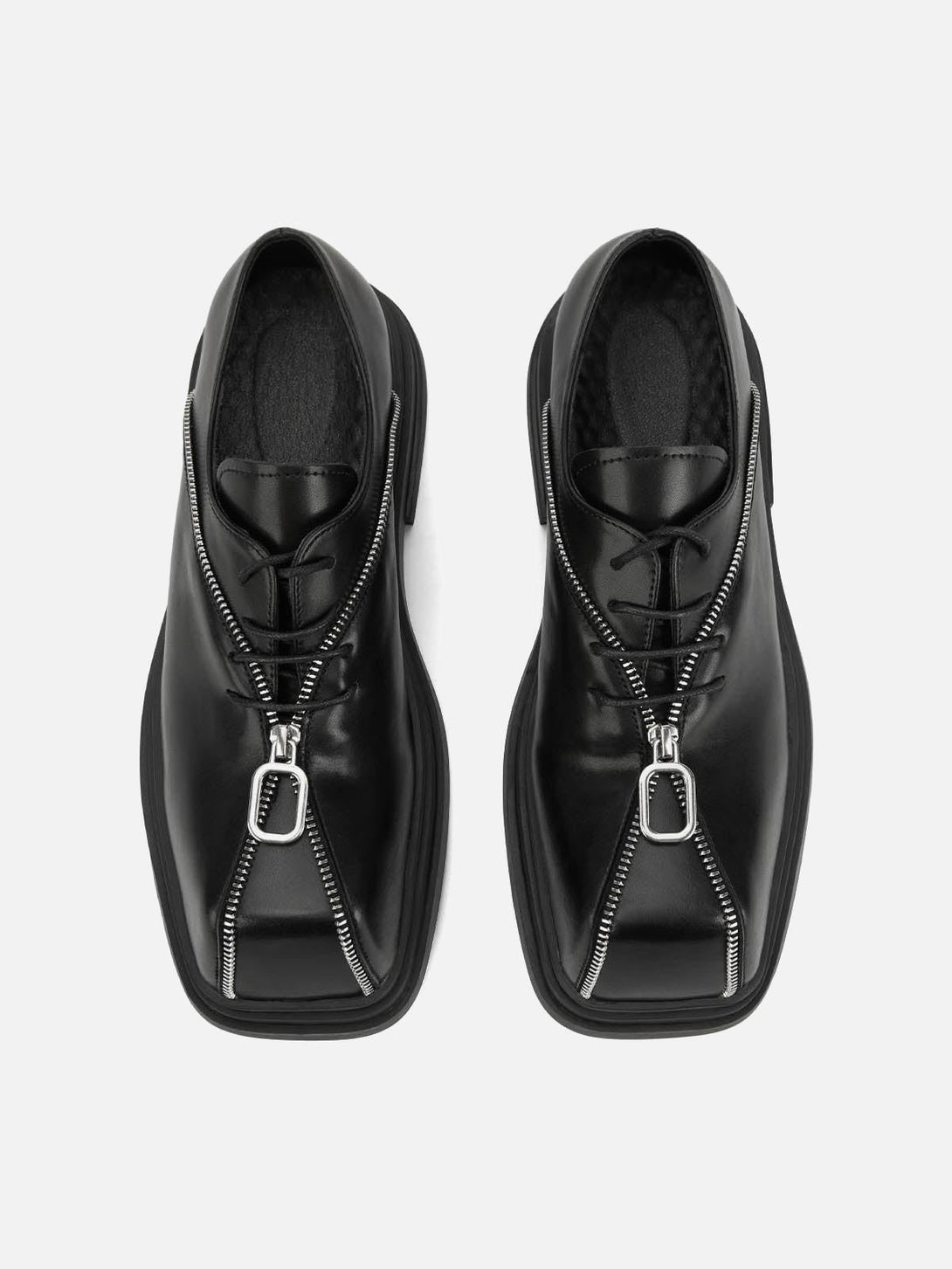 Top view of black leather shoes with bold zipper accents by TALISHKO, adding a punk edge.