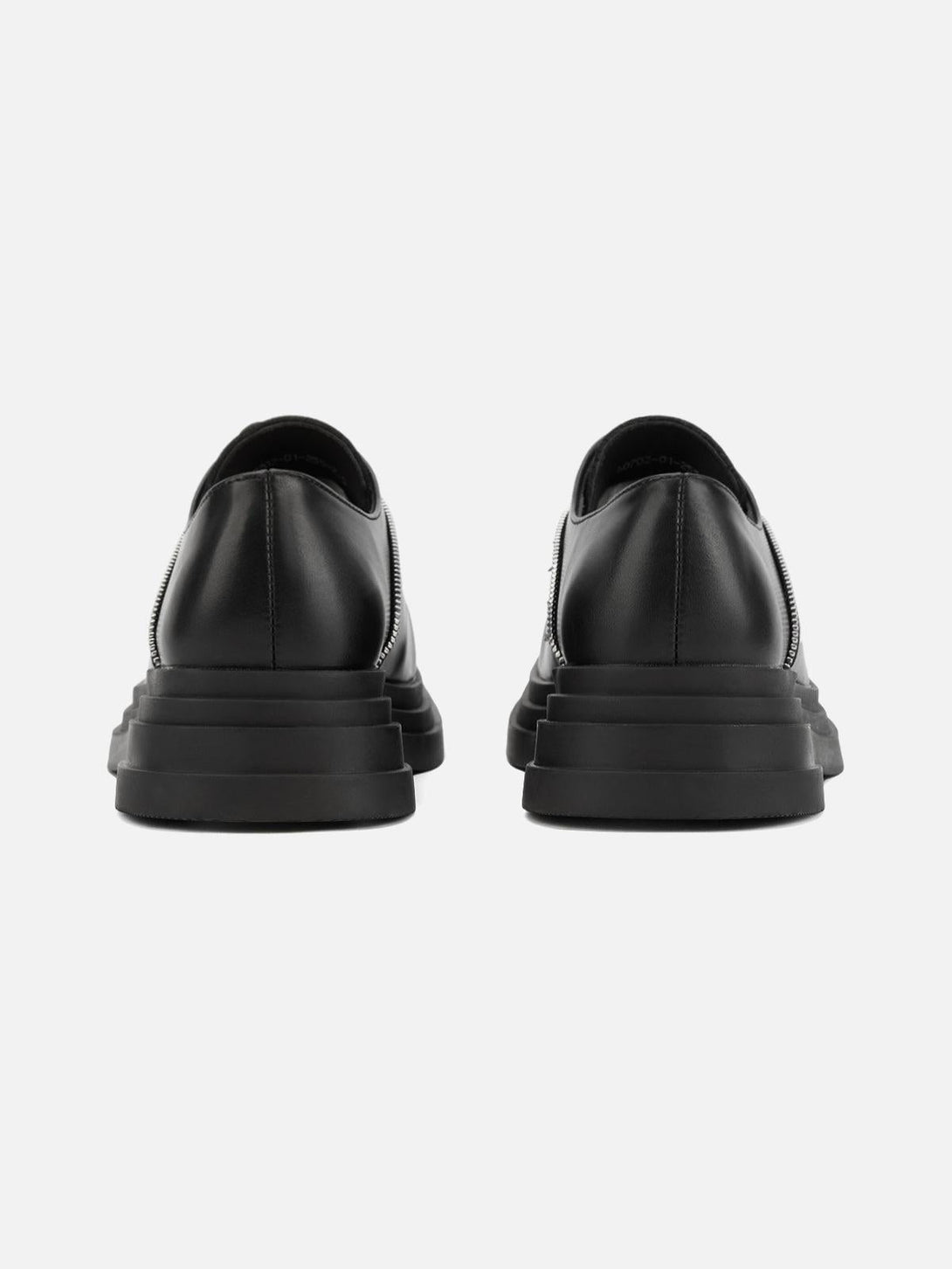 Back view of black leather shoes by TALISHKO, showcasing the edgy zipper detail for a bold look.