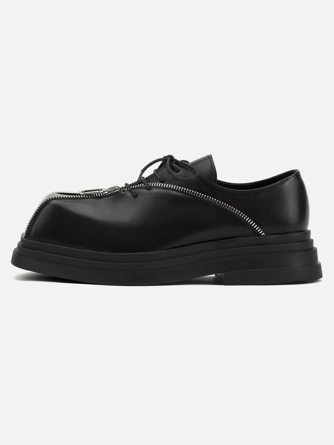 Side view of black leather shoes with a distinctive zipper design by TALISHKO, ideal for a bold look.