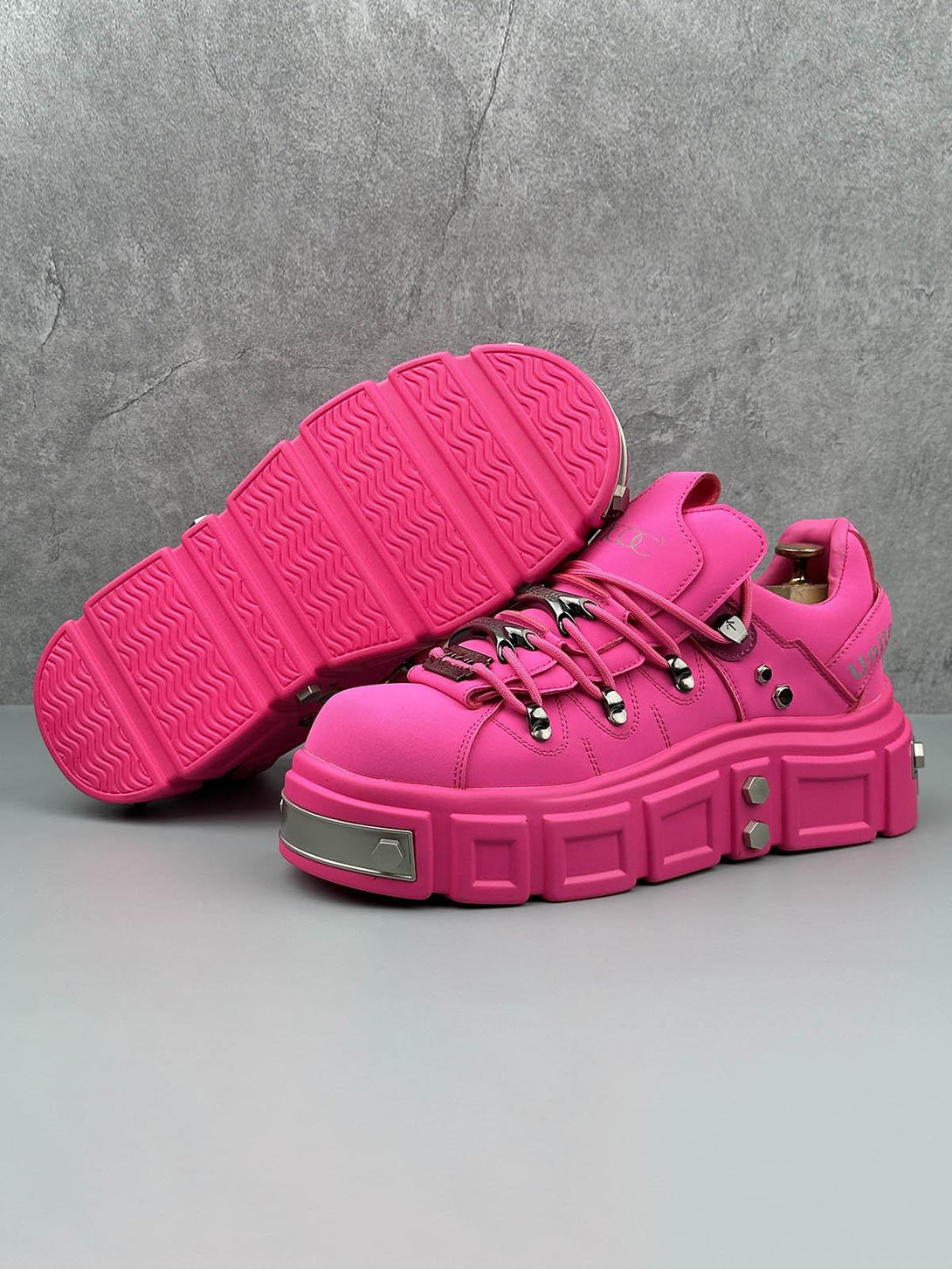 Bold pink derby shoes with chunky soles and rivet accents, showcasing TALISHKO’s punk style.