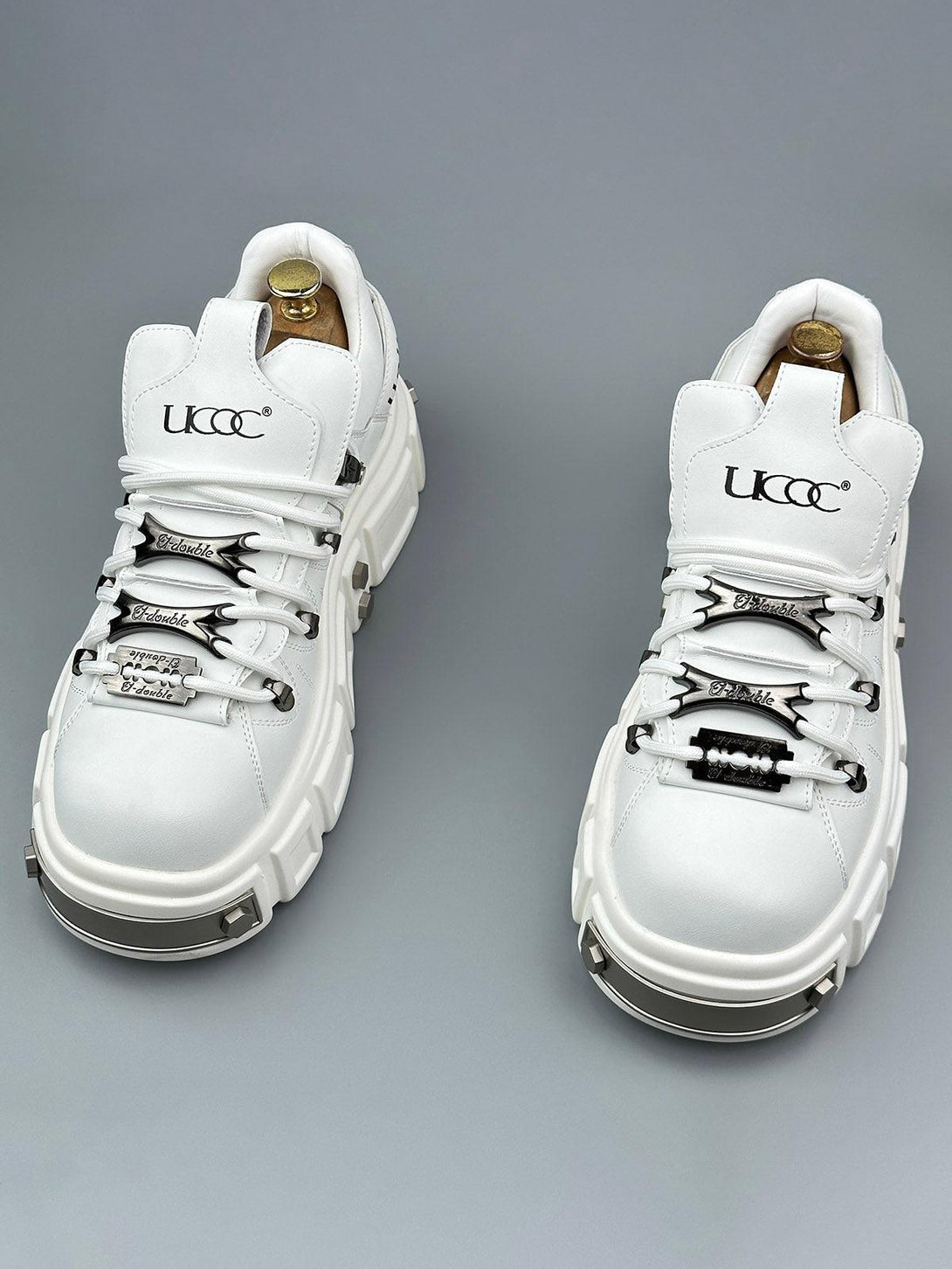 Chunky white derby shoes with rivet details by TALISHKO, highlighting a bold punk style.