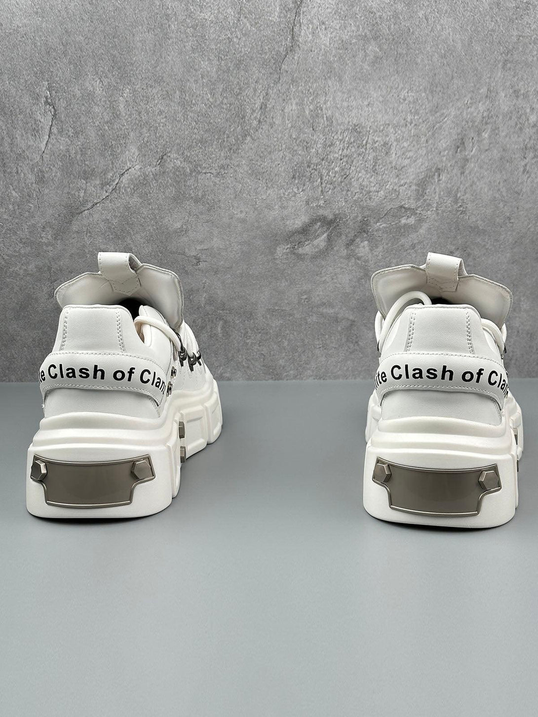 Back view of white derby shoes by TALISHKO, featuring chunky soles and edgy rivet details.